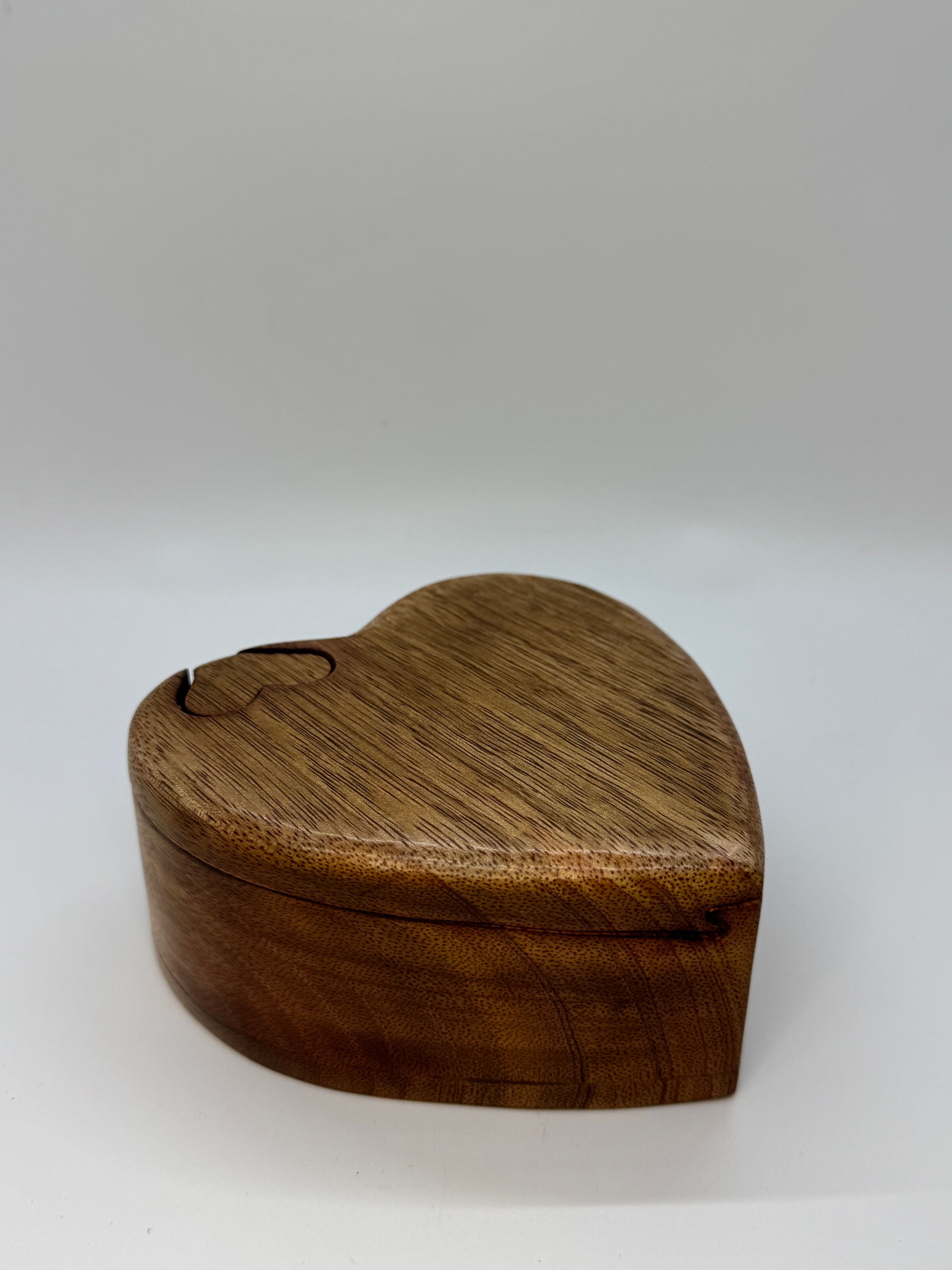 Wooden, heart shaped keepsake urn with puzzle-like closure.