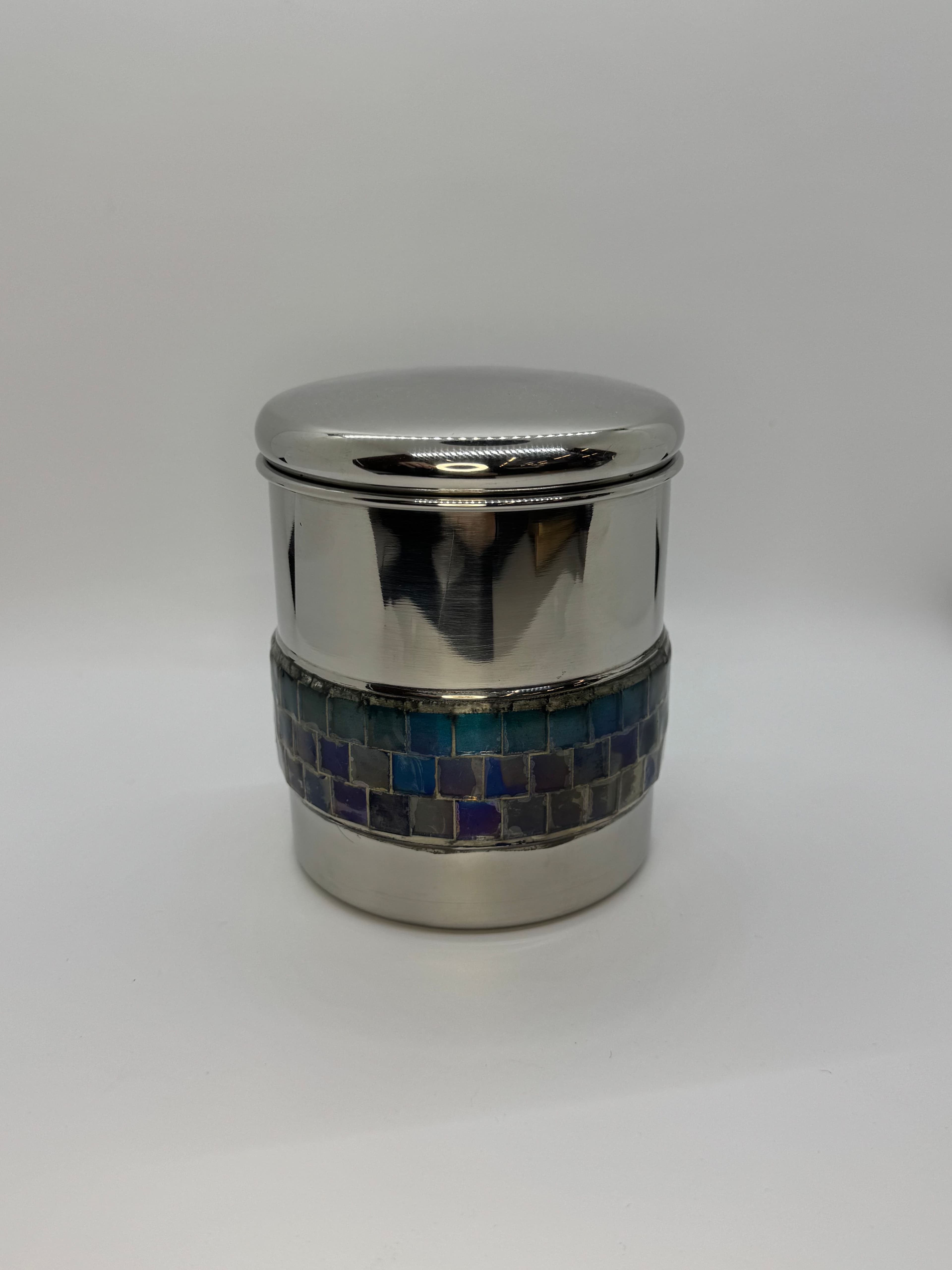 Silver canister urn with oceanic mosaic tile band.